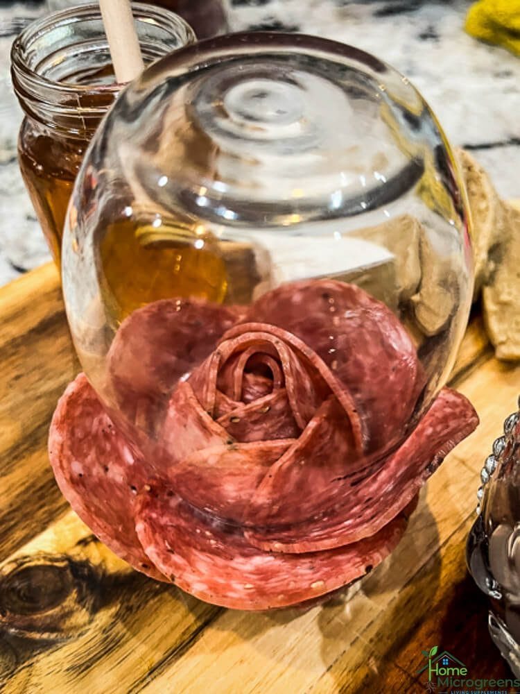 A salami rose made in a glass